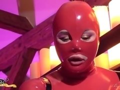Shemale in Red Latex is Ready to Dominate You with Her Hard Cock