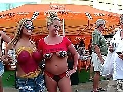 Body painted beauties playing at a street fair